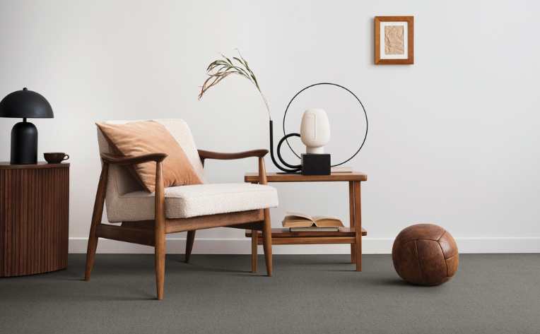 grey carpet flooring in mid century modern living room with wood furniture