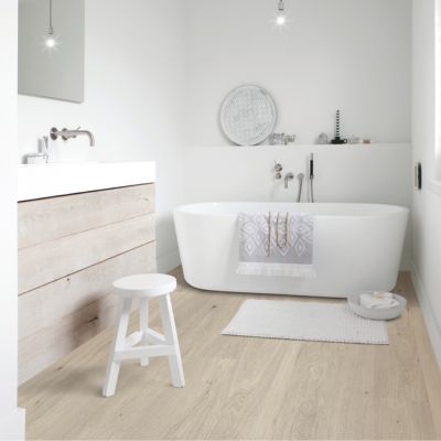 engineered hardwood floors in a bright Charlottetown bathroom with tub and vanity